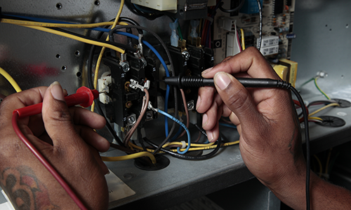 People working on AC unit