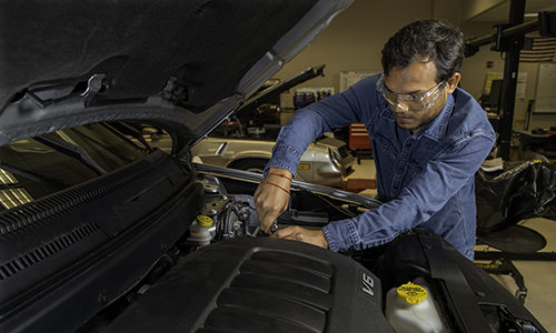 Image of person working on vehicle